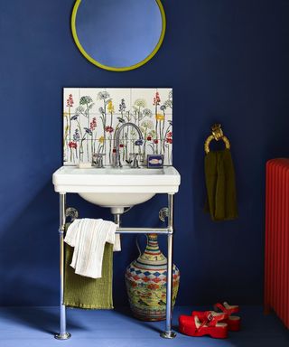 blue bathroom with stencilled backsplash, red shoes and radiator, blue floor, mirror, AnnieSloan_Stencils_MeadowFlowers_Bathroom_NapoleonicB