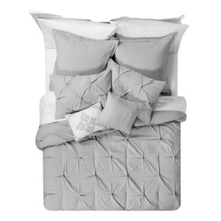 Bed with gray duvet and throw pillows