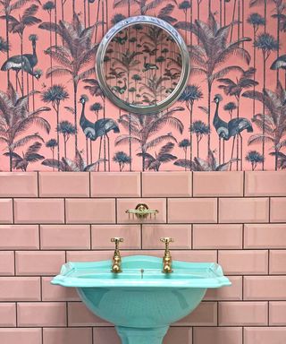 pink bathroom with pink wallpaper, pink metro tiles and aqua sink, mirror