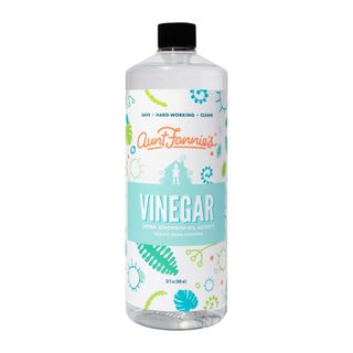 Bottle of vinegar on white background