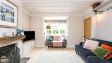 living room with navy sofa and bay window