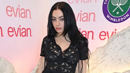 Charli XCX on red carpet in black dress