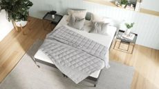 Gray weighted blanket on white bed