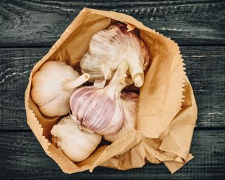 garlic bulbs in brown paper bag